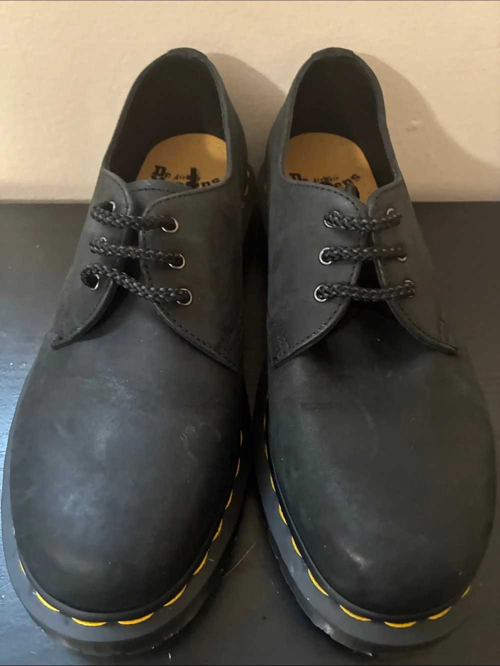 Dr. Martens 1461 leather oxfords feature the brand's signature yellow size 8